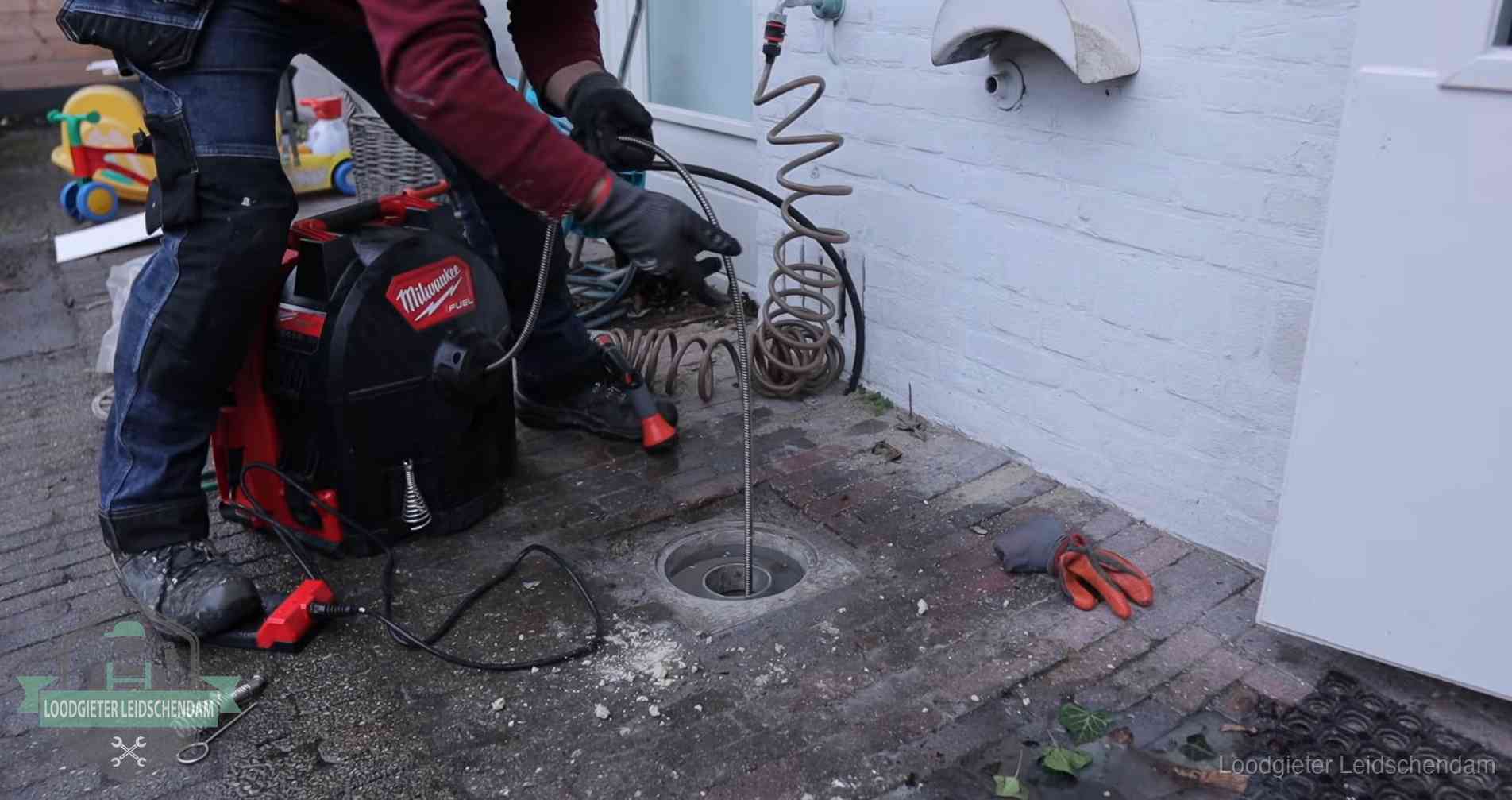 Erfgrens en gemeenteriool in Leidschendam Ontstoppingsputje in de bestrating naast de gevel van een woning in Leidschendam